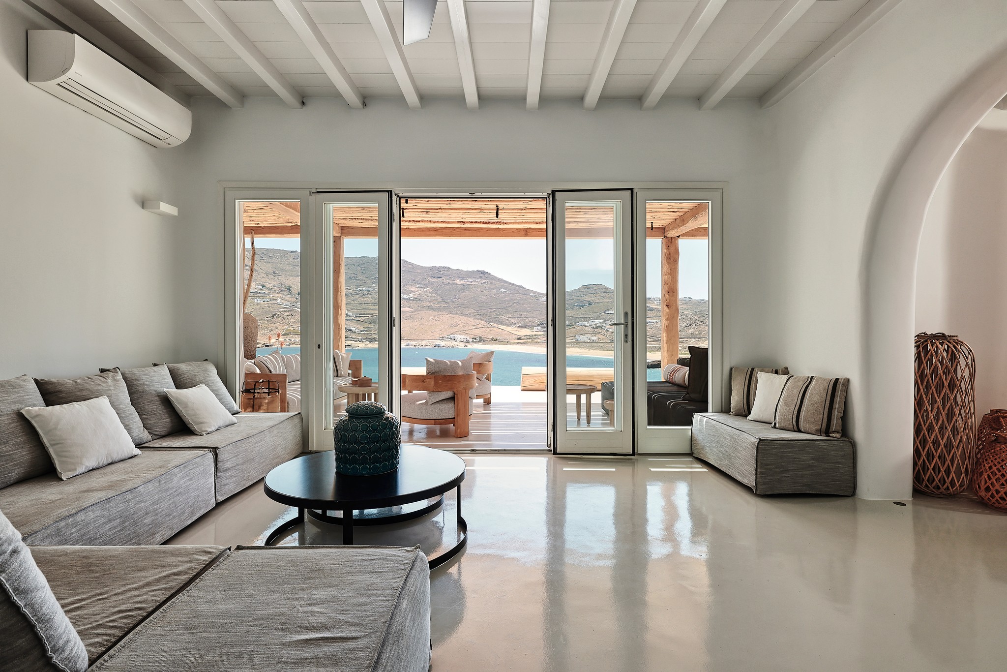 Living area with traditional Mykonian character at Bali Sea Front Villa in Ftelia, Mykonos