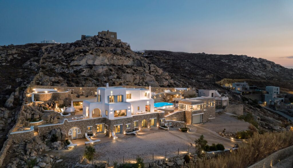 Grand Kanalia estate at dusk on the Kanalia hillside overlooking the Aegean – Grand Kanalia estate for sale in Kanalia, Mykonos