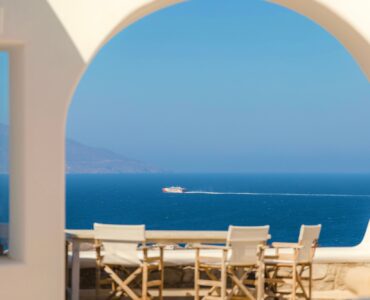 Arched terrace dining area framing the Aegean Sea – Grand Kanalia estate for sale in Kanalia, Mykonos