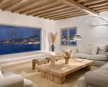 Lounge with panoramic window over Mykonos Town – Grand Kanalia estate for sale in Kanalia, Mykonos