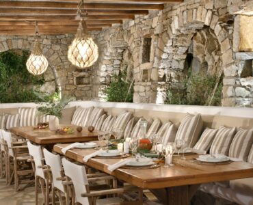 Pergola dining terrace with stone arches and lanterns – Grand Kanalia estate for sale in Kanalia, Mykonos