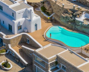 Curved infinity pool and veranda of the main villa – Grand Kanalia estate for sale in Kanalia, Mykonos