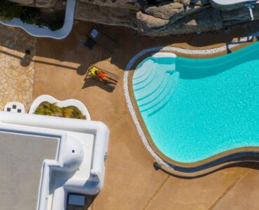 Overhead view of the sculpted infinity pool – Grand Kanalia estate for sale in Kanalia, Mykonos