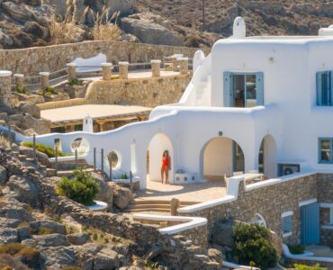 Villa facade with arched verandas and stone terraces – Grand Kanalia estate for sale in Kanalia, Mykonos