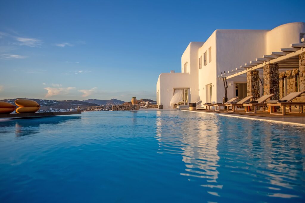 Infinity pool and the villa at Maison Haute in Aleomandra, Mykonos