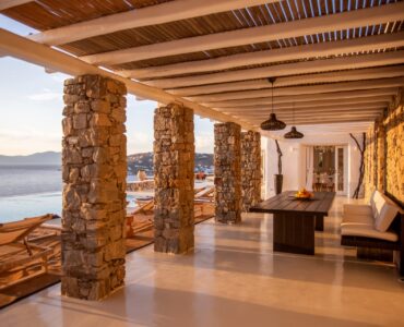 Stone-pillared veranda with sea view at Maison Haute in Aleomandra, Mykonos