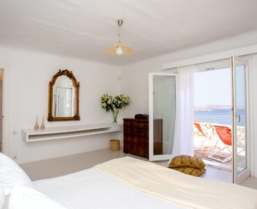 Bedroom with terrace doors at Maison Haute in Aleomandra, Mykonos