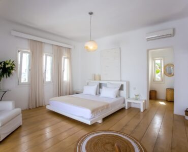 Bedroom with wooden floor at Maison Haute in Aleomandra, Mykonos