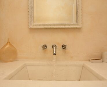 Bathroom with stone basin at Maison Haute in Aleomandra, Mykonos
