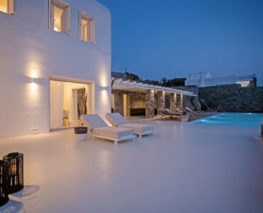 Villa and pool at dusk at Maison Haute in Aleomandra, Mykonos