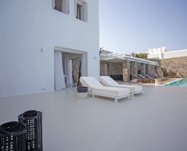 Pool terrace with sun loungers at Maison Haute in Aleomandra, Mykonos