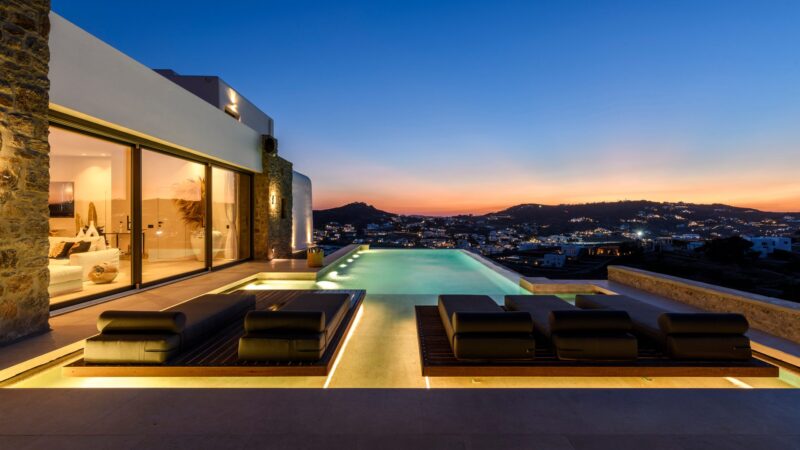 Pool lit at dusk with sunset view at Muse Mansion in Agios Lazaros, Mykonos