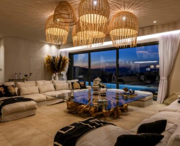 Living room with panoramic windows at Muse Mansion in Agios Lazaros, Mykonos