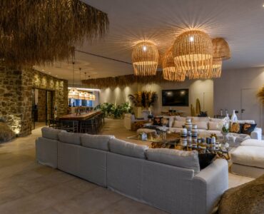 Living room with stone walls at Muse Mansion in Agios Lazaros, Mykonos