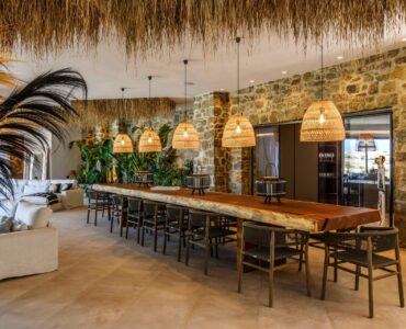 Dining area with stone walls at Muse Mansion in Agios Lazaros, Mykonos