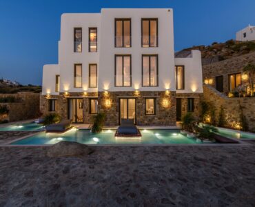 Villa and pool at dusk at Muse Mansion in Agios Lazaros, Mykonos