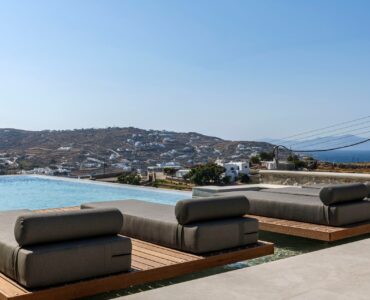 Poolside daybeds with sea view at Muse Mansion in Agios Lazaros, Mykonos