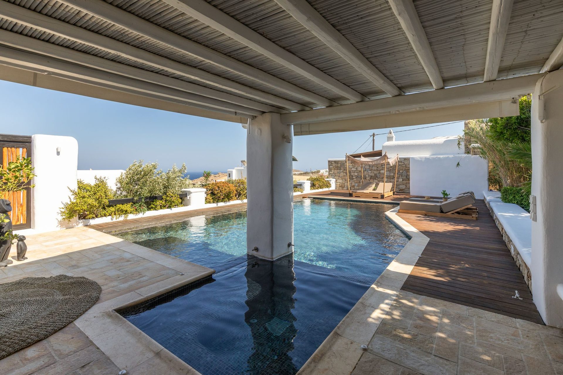 Covered veranda by the pool at Platinum Deluxe Villa in Kalafatis, Mykonos