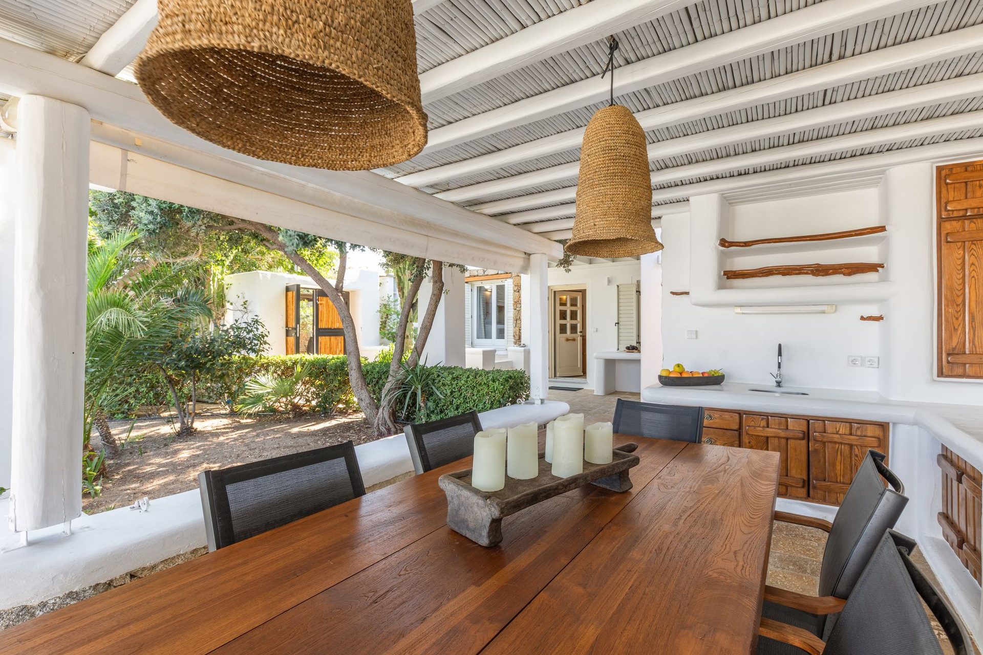 Dining area with garden view at Platinum Deluxe Villa in Kalafatis, Mykonos