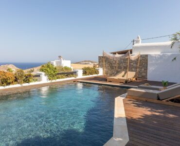 Pool with wooden deck at Platinum Deluxe Villa in Kalafatis, Mykonos