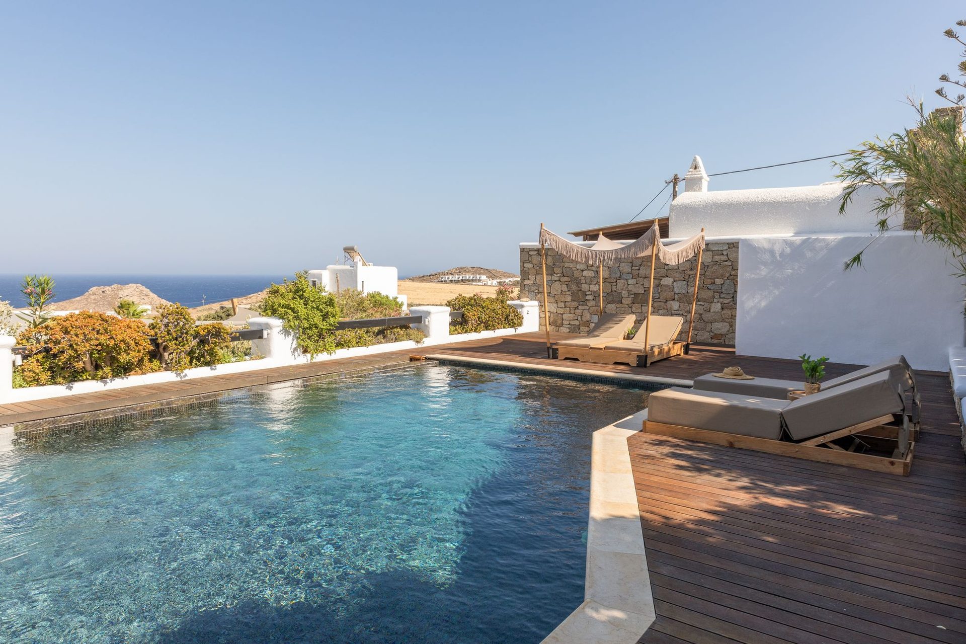 Pool with wooden deck at Platinum Deluxe Villa in Kalafatis, Mykonos