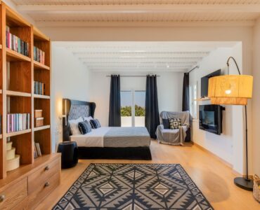 Bedroom with bookshelves at Platinum Deluxe Villa in Kalafatis, Mykonos