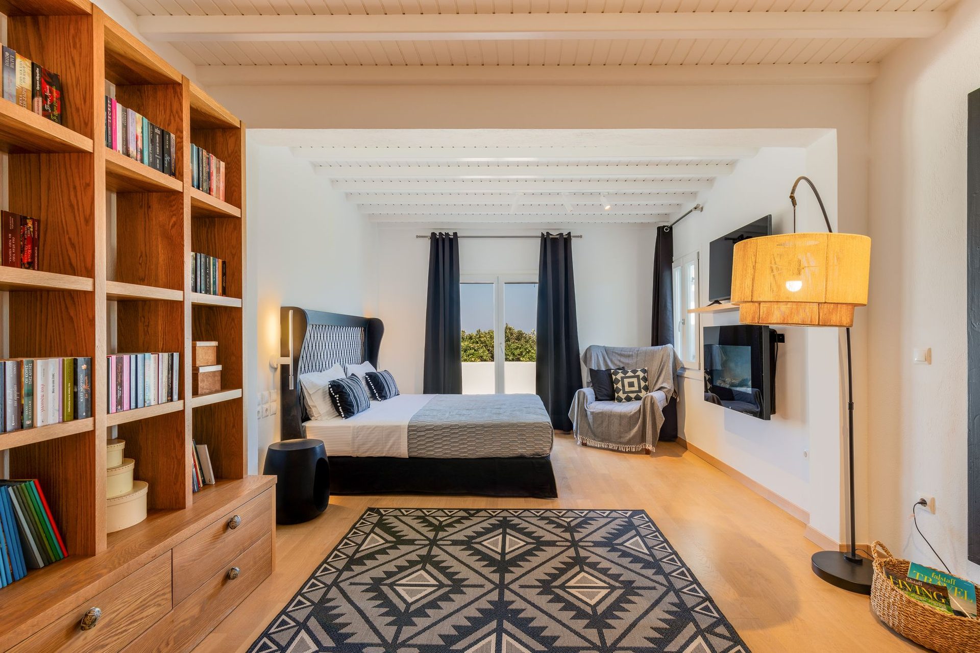 Bedroom with bookshelves at Platinum Deluxe Villa in Kalafatis, Mykonos