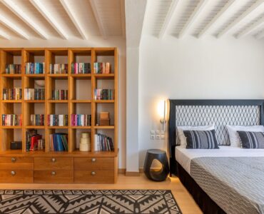 Bedroom with library wall at Platinum Deluxe Villa in Kalafatis, Mykonos