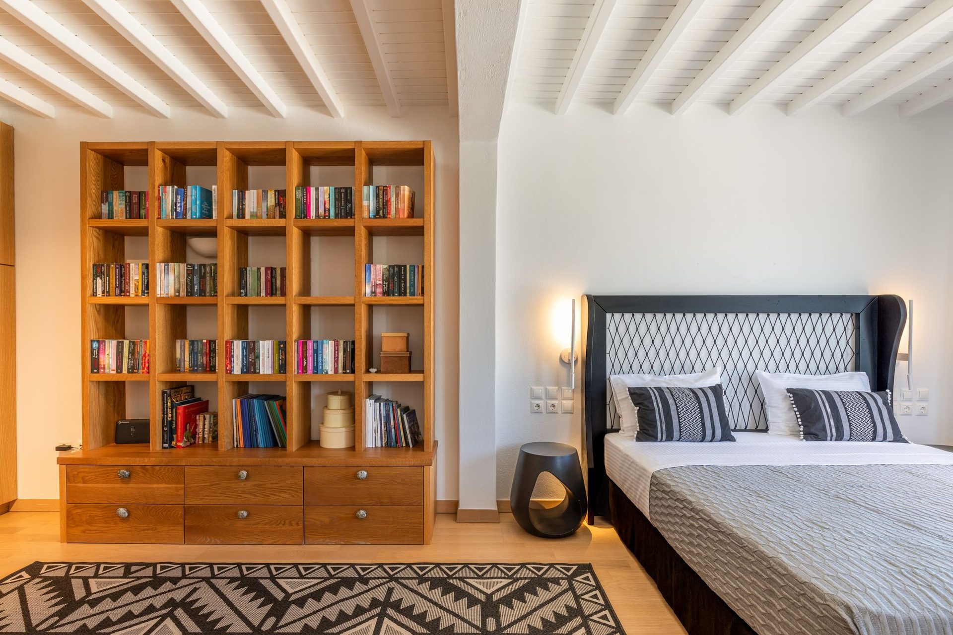 Bedroom with library wall at Platinum Deluxe Villa in Kalafatis, Mykonos