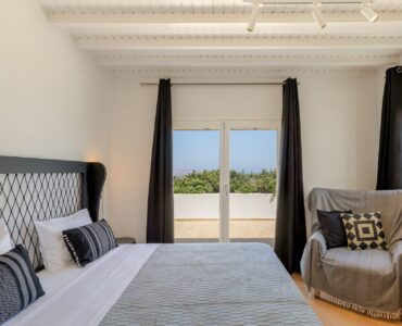 Bedroom with terrace door at Platinum Deluxe Villa in Kalafatis, Mykonos