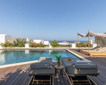 Pool deck with sun loungers at Platinum Deluxe Villa in Kalafatis, Mykonos