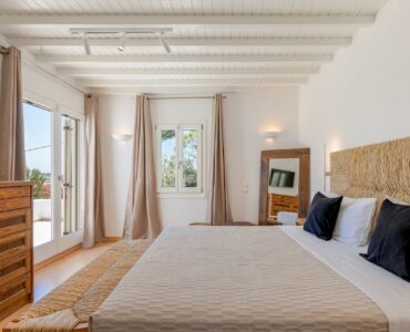 Bedroom with garden-view windows at Platinum Deluxe Villa in Kalafatis, Mykonos