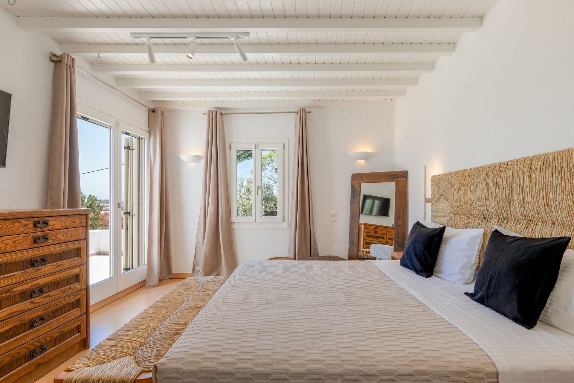Bedroom with garden-view windows at Platinum Deluxe Villa in Kalafatis, Mykonos
