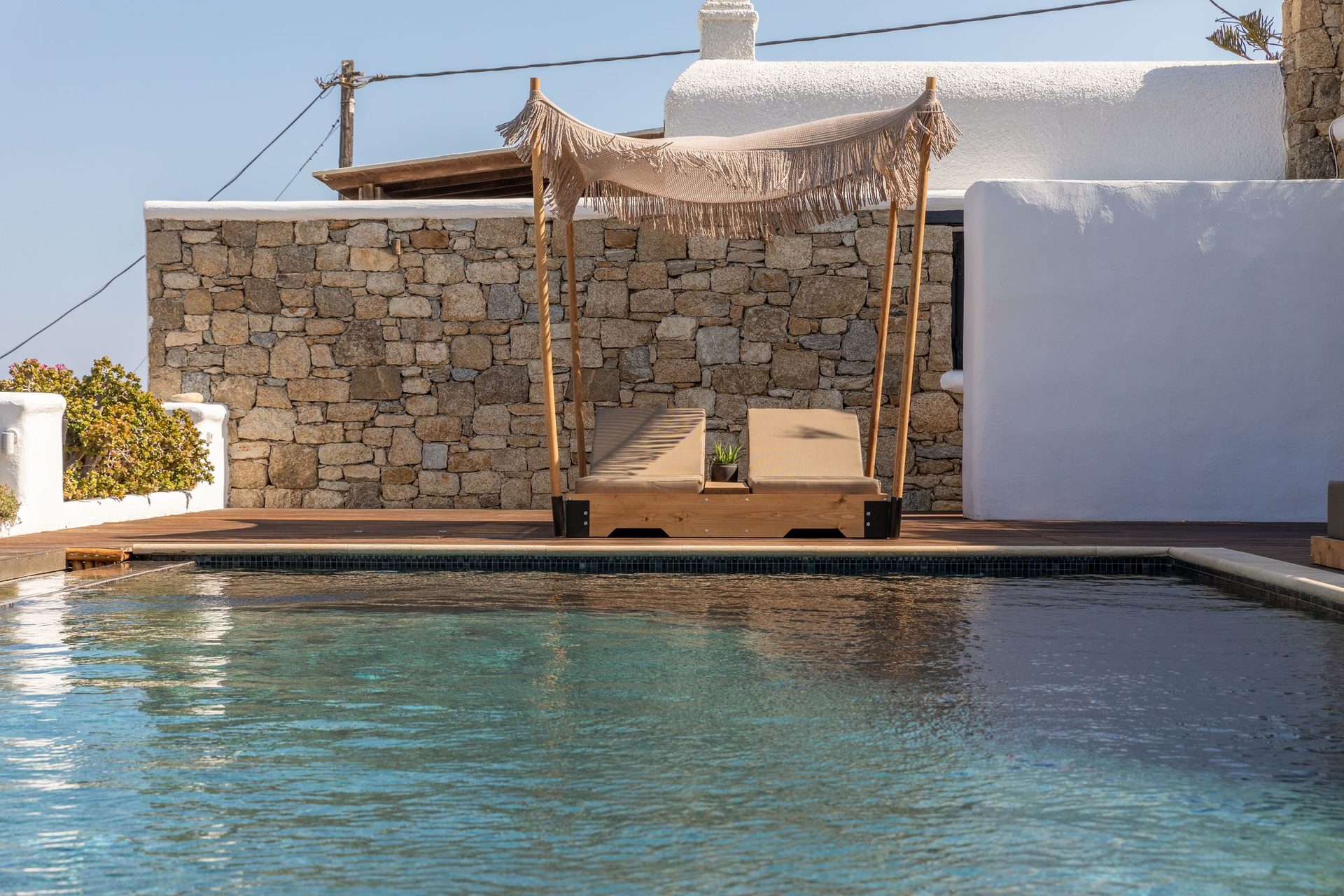 Pool and stone wall at Platinum Deluxe Villa in Kalafatis, Mykonos