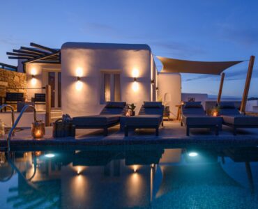 Villa and pool at dusk at Platinum Junior Villa in Kalafatis, Mykonos