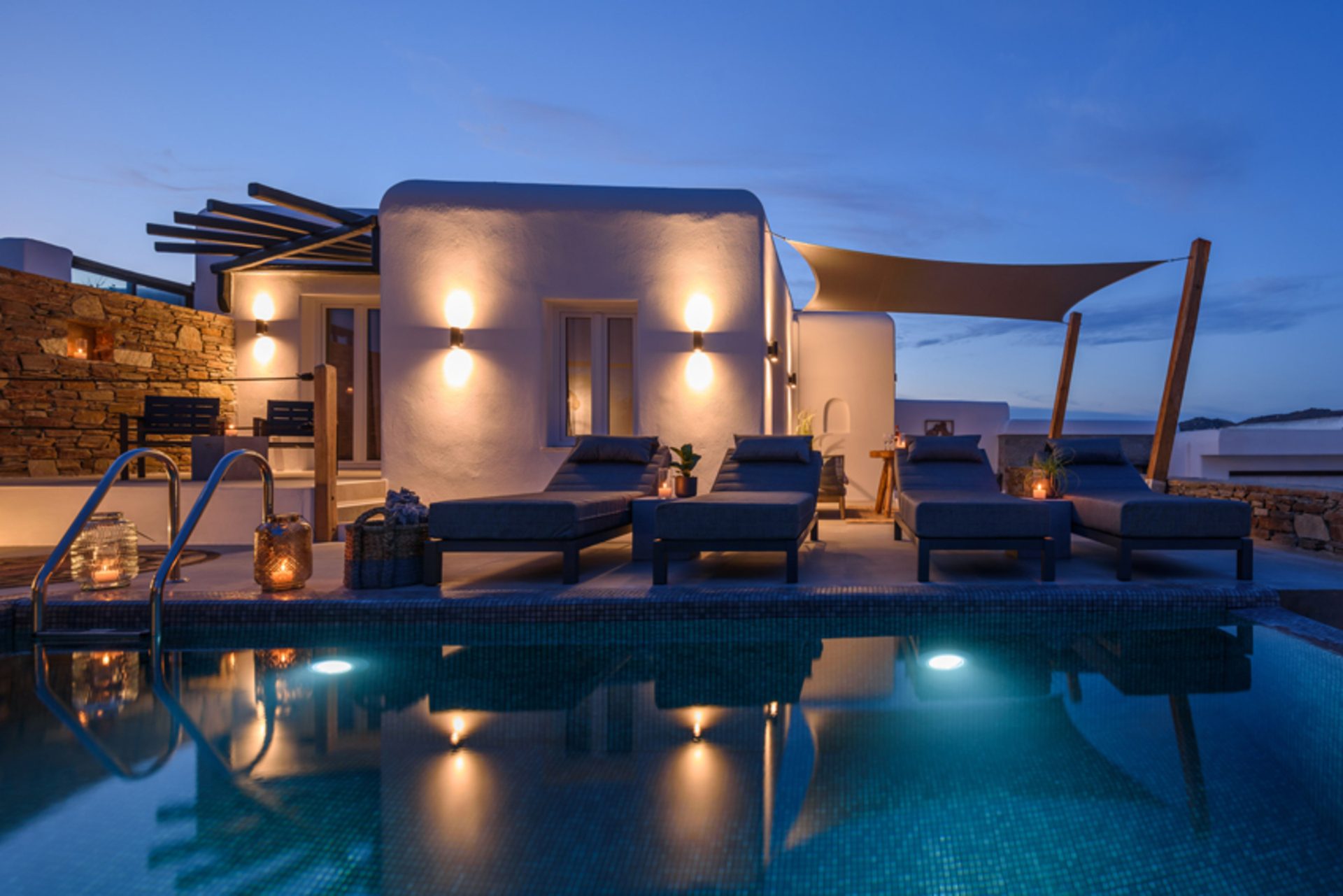 Villa and pool at dusk at Platinum Junior Villa in Kalafatis, Mykonos