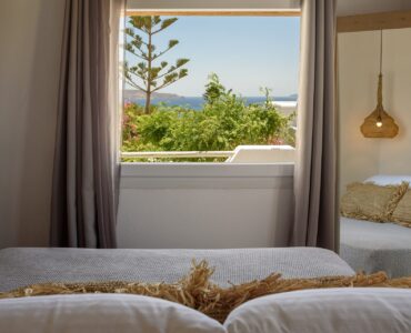 Bedroom with garden-view window at Platinum Junior Villa in Kalafatis, Mykonos