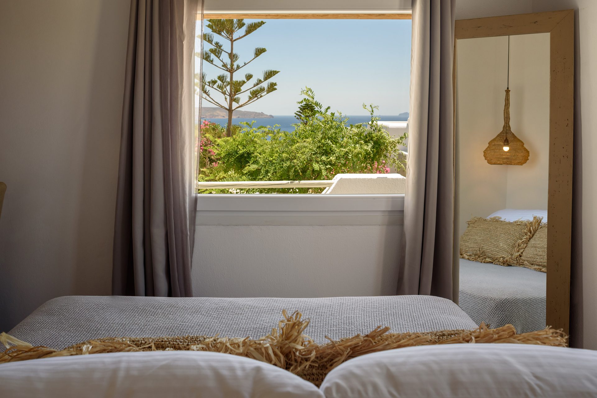 Bedroom with garden-view window at Platinum Junior Villa in Kalafatis, Mykonos