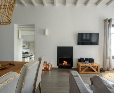 Living room with fireplace at Platinum Senior Villa in Kalafatis, Mykonos