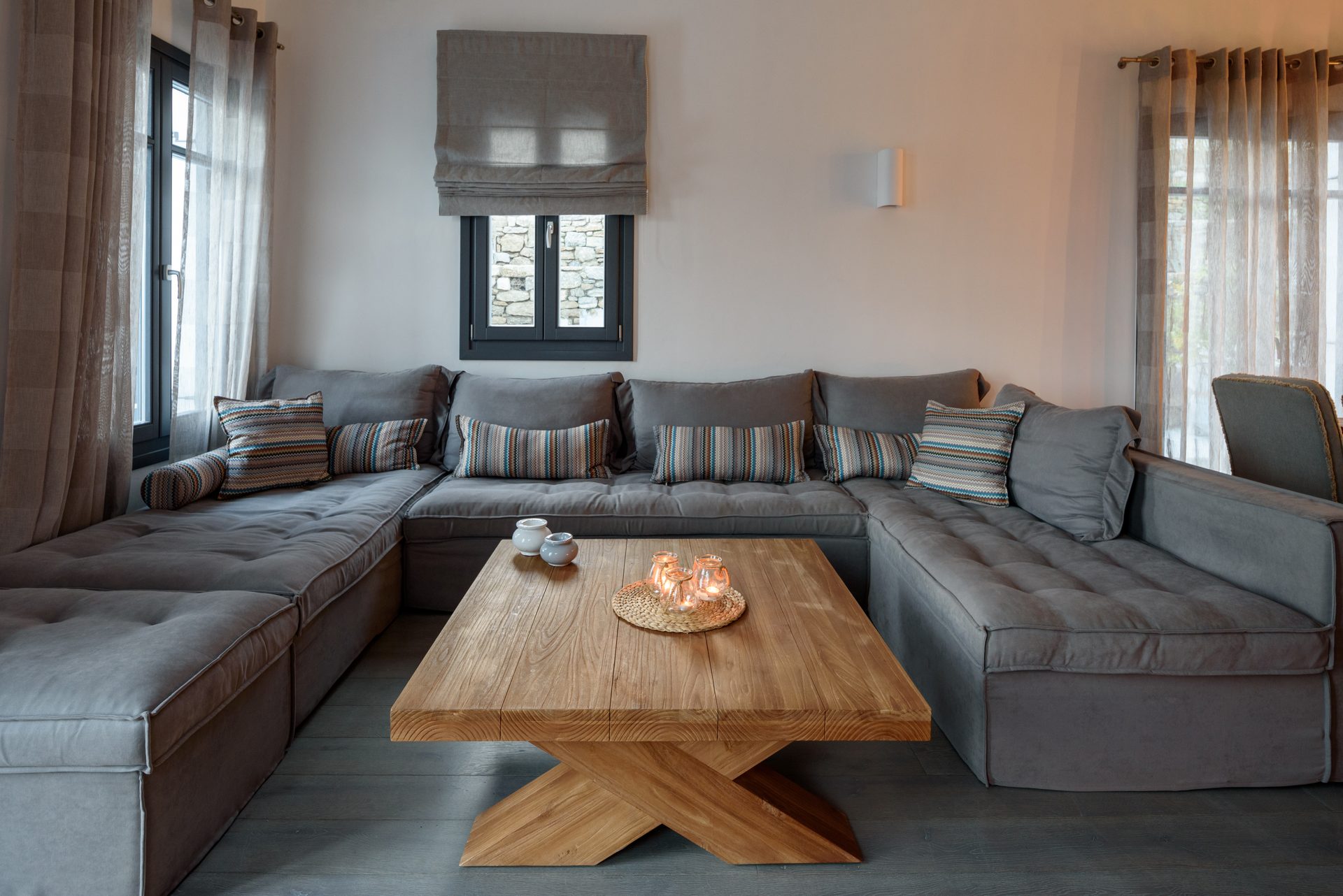 Lounge with large sofa at Platinum Senior Villa in Kalafatis, Mykonos