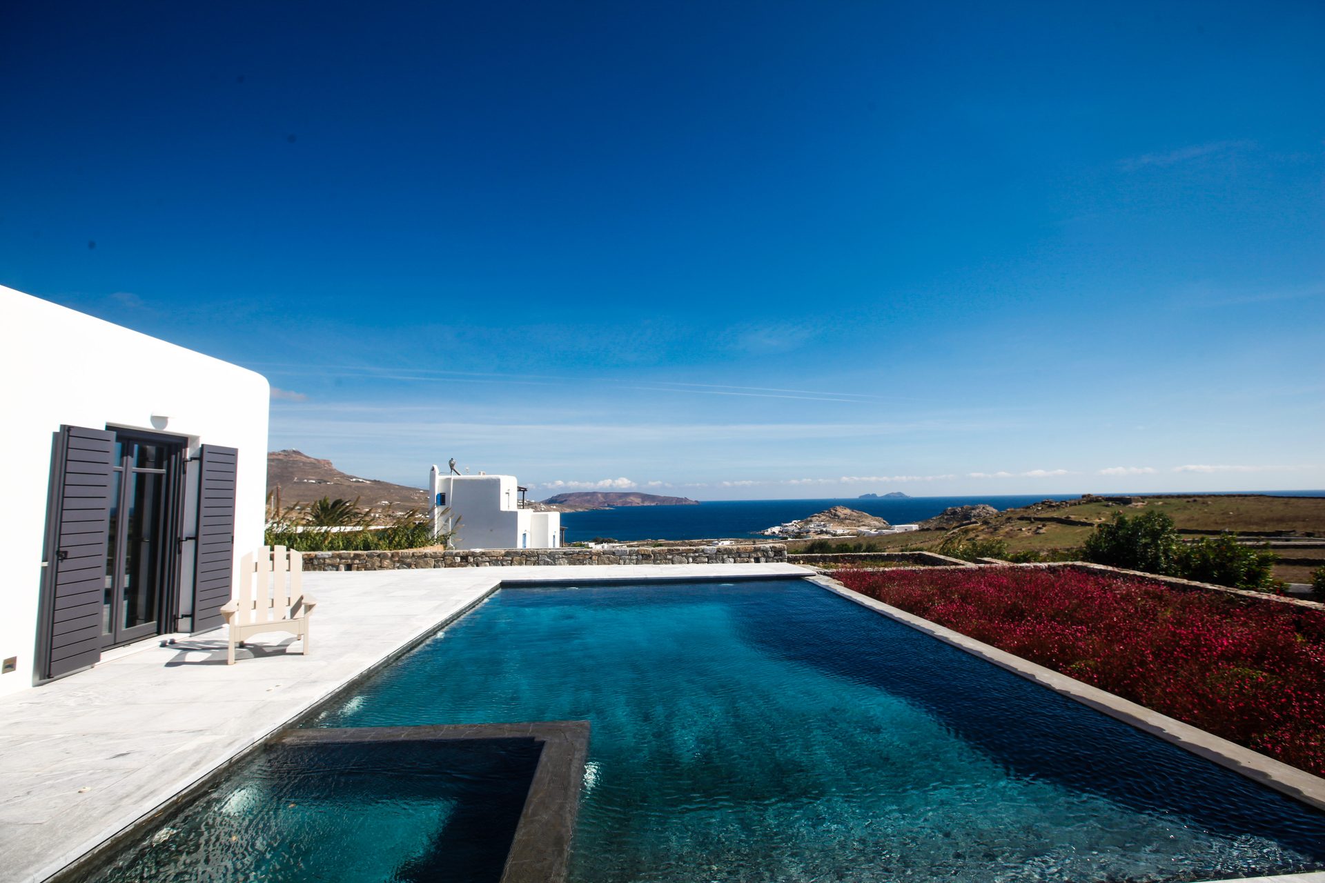 Pool and whitewashed villa at Platinum Senior Villa in Kalafatis, Mykonos