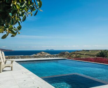 Pool with sea view and loungers at Platinum Senior Villa in Kalafatis, Mykonos