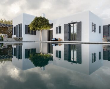 Villa reflected in the pool at Platinum Senior Villa in Kalafatis, Mykonos
