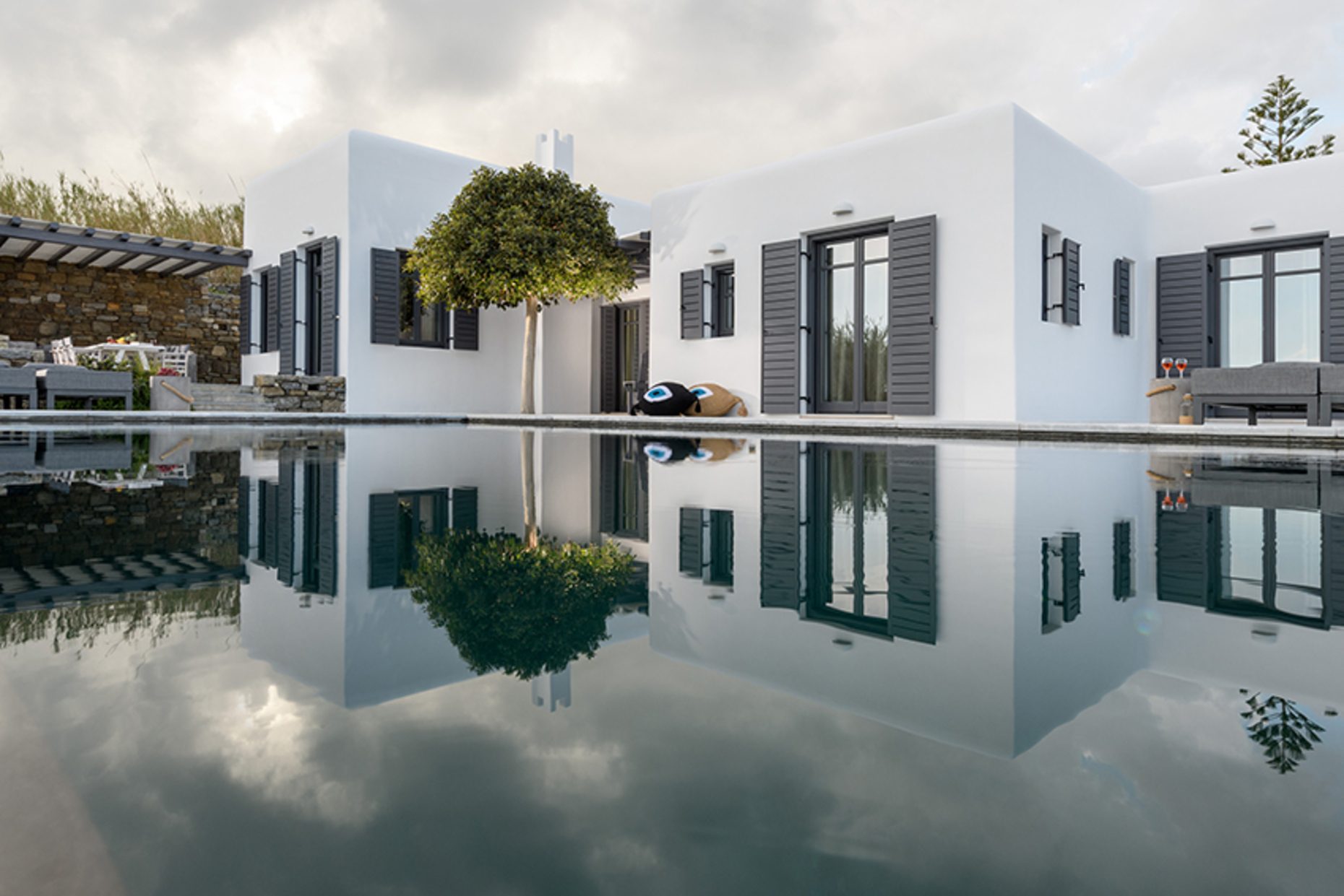 Villa reflected in the pool at Platinum Senior Villa in Kalafatis, Mykonos
