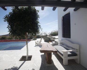 Shaded terrace with olive tree at Platinum Senior Villa in Kalafatis, Mykonos