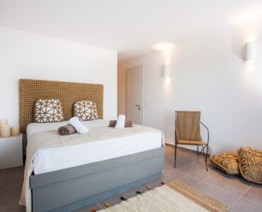 Bedroom with armchair at Platinum Superior Villa in Kalafatis, Mykonos