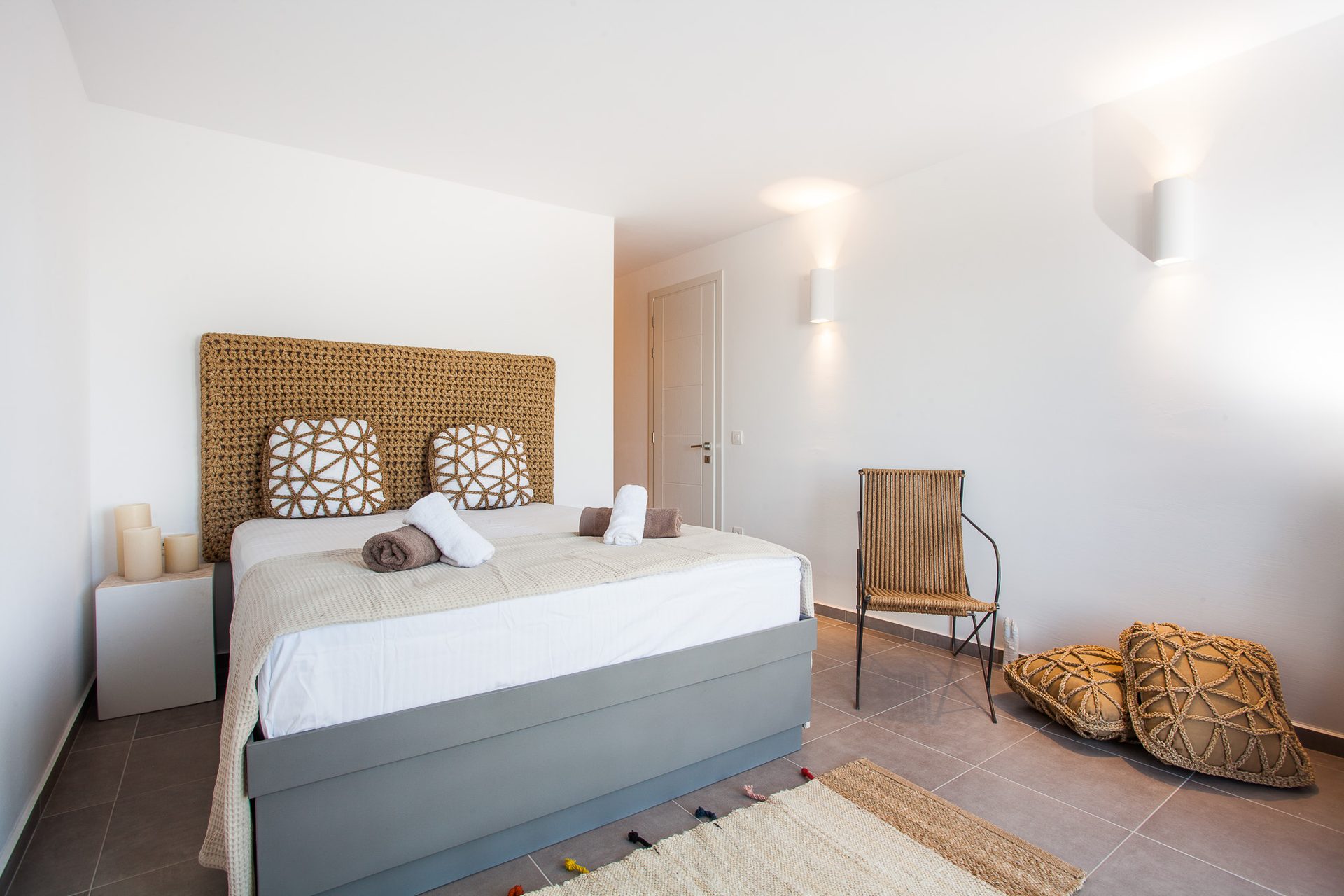 Bedroom with armchair at Platinum Superior Villa in Kalafatis, Mykonos