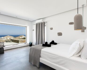 Bedroom with sea-view window at Platinum Superior Villa in Kalafatis, Mykonos