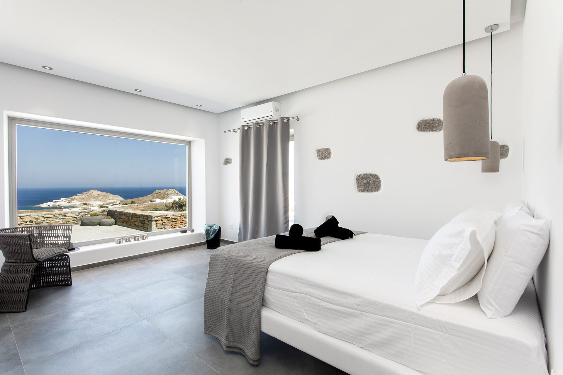 Bedroom with sea-view window at Platinum Superior Villa in Kalafatis, Mykonos