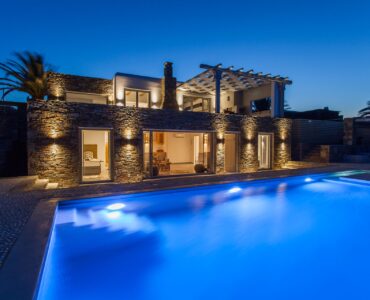 Pool and villa at dusk at Platinum Superior Villa in Kalafatis, Mykonos